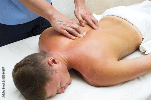 young man on wellness treatments sports massage