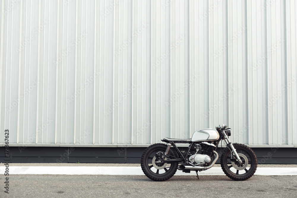 motorcycle standing in dark building in rays of sunlight motorcycle standing in dark building in rays of sunlight