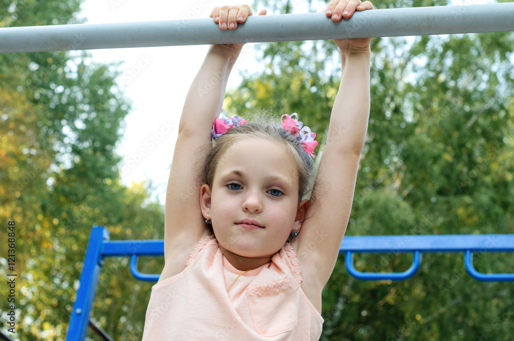 Small girl doing sports exercises in the park Small girl doing sports exercises in the park