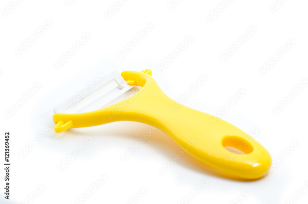 Yellow ceramic peeler for fruits and vegetables isolated on whit Yellow ceramic peeler for fruits and vegetables isolated on whit