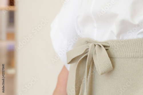Beige draw string waist casual woman pants style close up details. Minimal trendy fashion.
