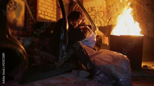 The homeless sitting around the campfire