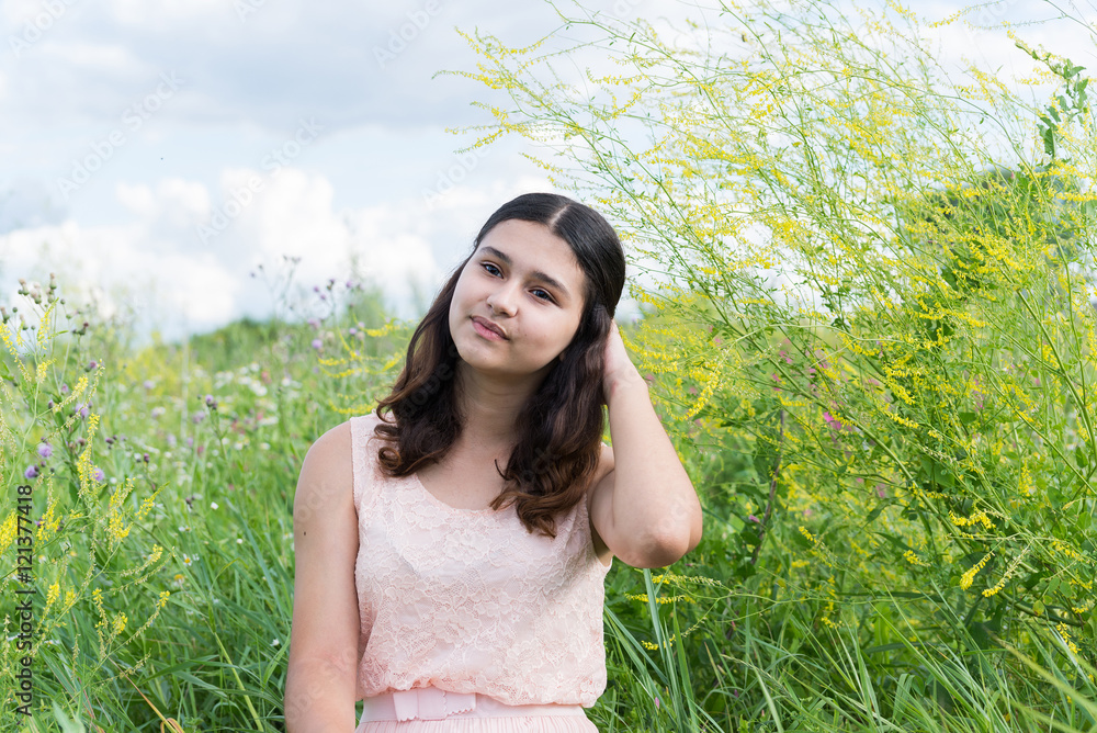 Young girl resting on meadow in summer Young girl resting on meadow in summer