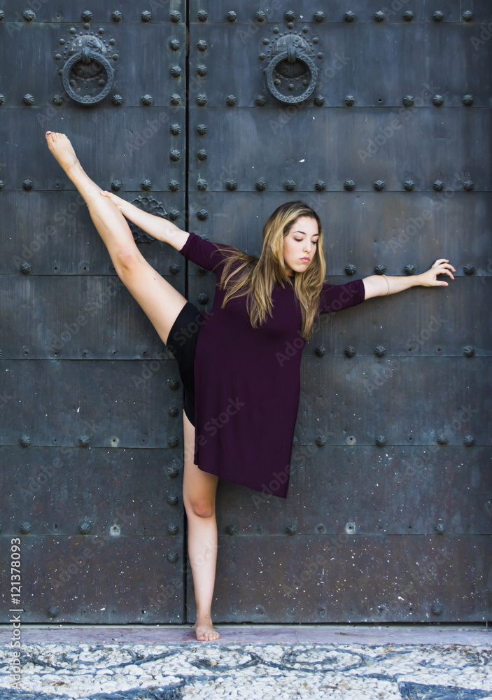 Beautiful ballerina doing exercises for dancing outdoors Beautiful ballerina doing exercises for dancing outdoors
