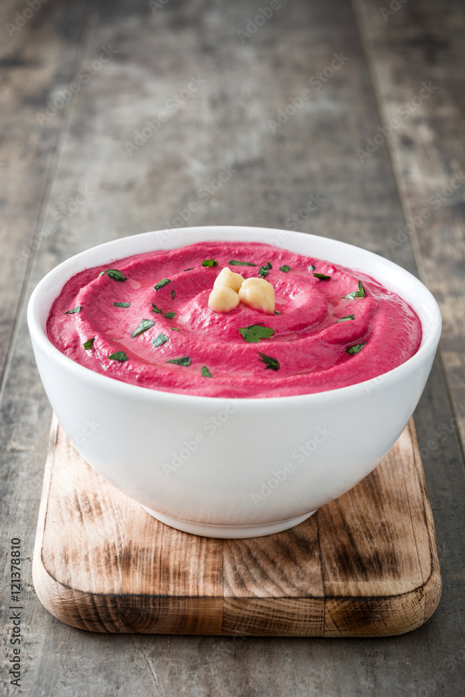 Beet hummus and ingredients on wooden table
Beet hummus and ingredients on wooden table