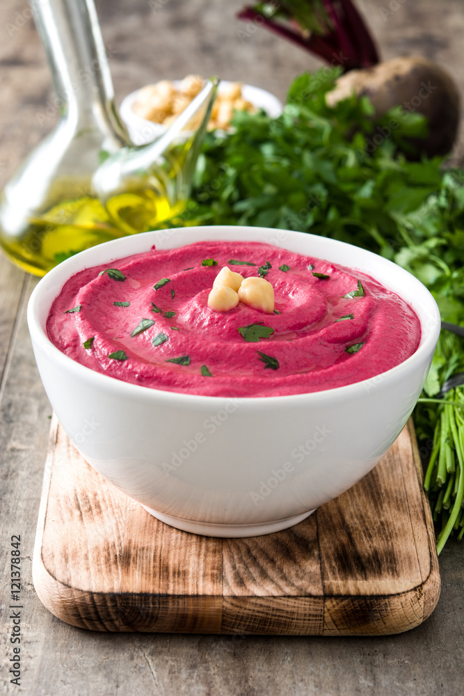 Beet hummus and ingredients on wooden table
Beet hummus and ingredients on wooden table