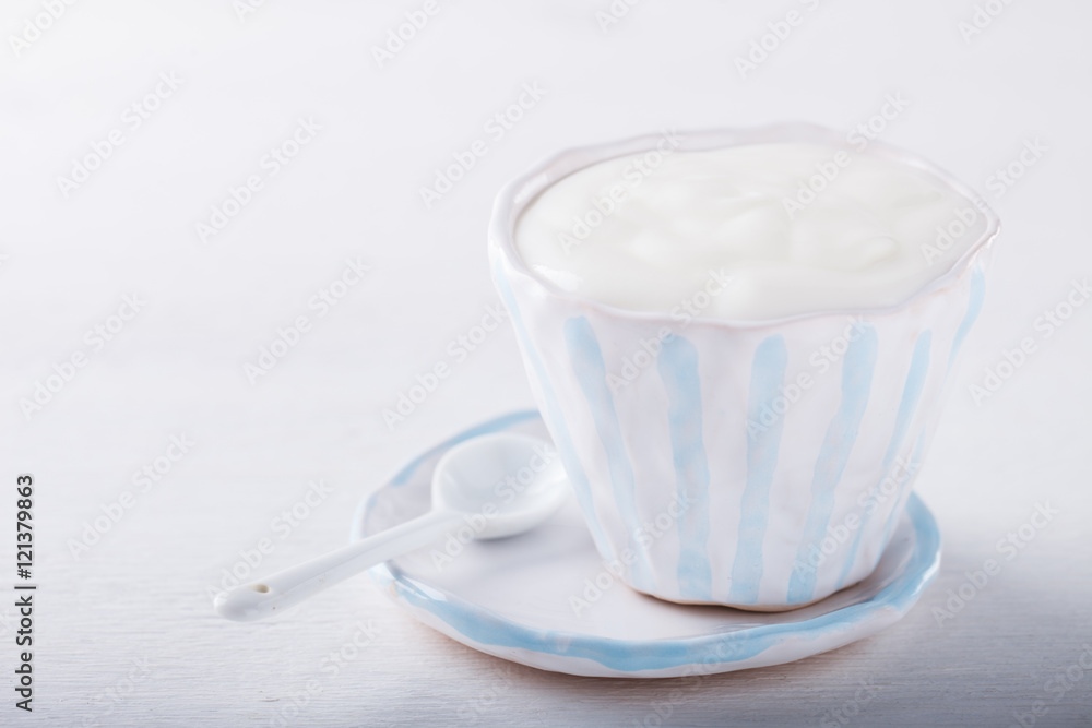 Yogurt,homemade in a ceramic bowl on a white background.Breakfast.Healthy food or diet concept.selective focus. Yogurt,homemade in a ceramic bowl on a white background.Breakfast.Healthy food or diet concept.selective focus.