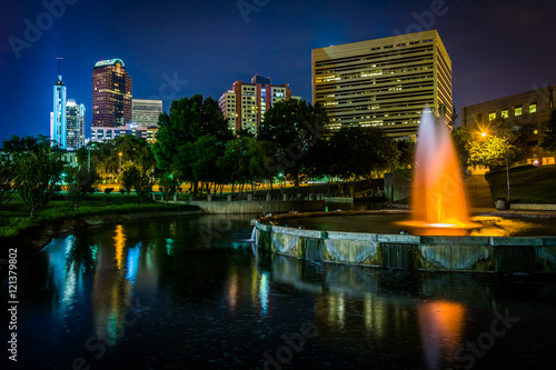The Uptown skyline and a fountain at Marshall Park at night, in