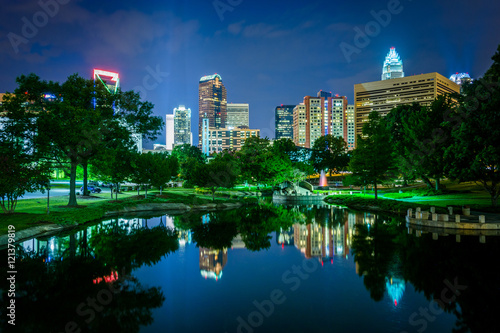 The Uptown skyline and a lake at Marshall Park at night, in Char