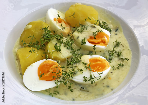 boiled eggs in mustard sauce, potatoes and fresh cress