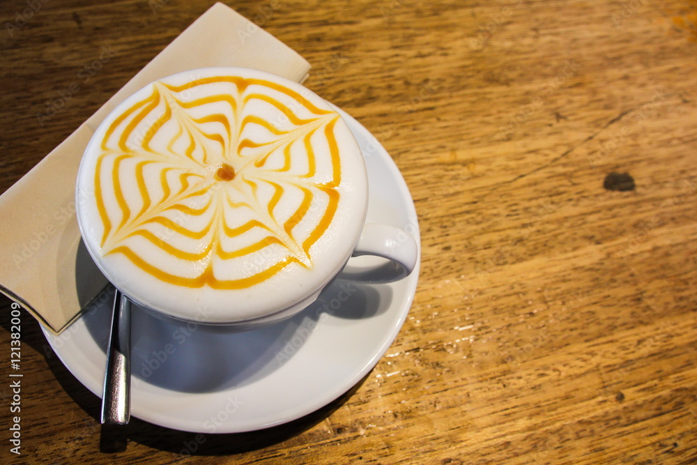 Honey cappuccino coffee on the wood table.