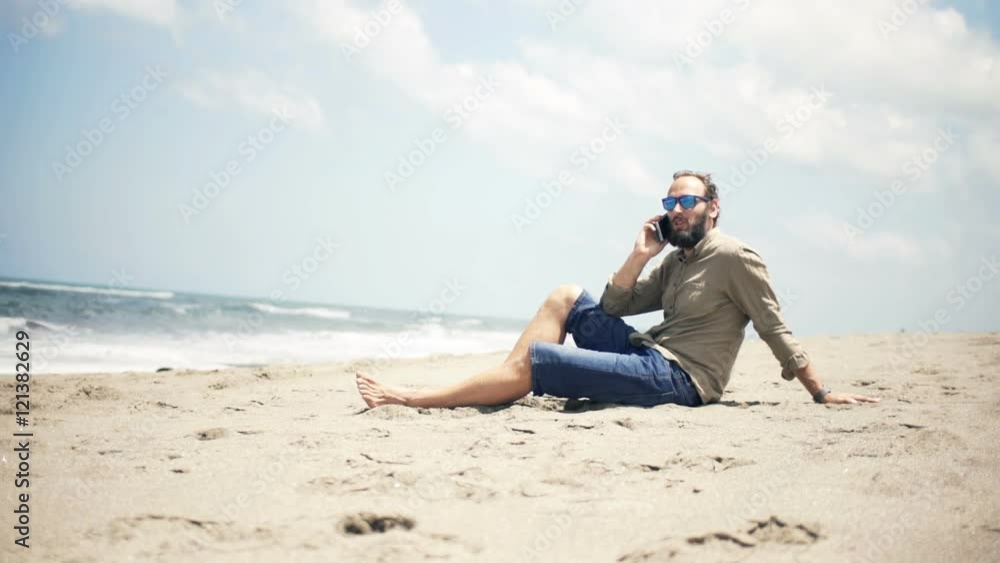 Young man talking on cellphone standing on beach near sea
Young man talking on cellphone standing on beach near sea