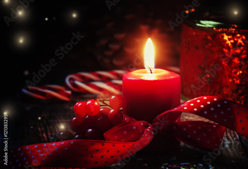 New Year or Christmas composition with red burning candle  ribbo