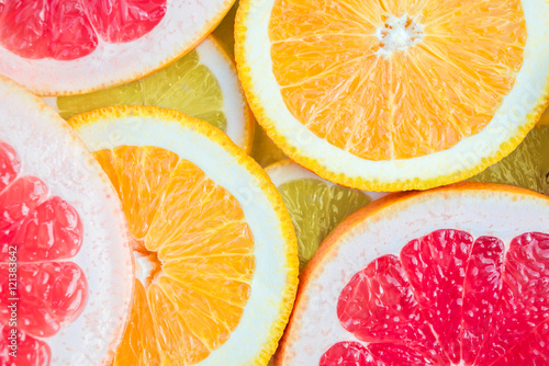 Bright and fresh lemon, orange, grapefruit. Colorful citrus fruit slices background.