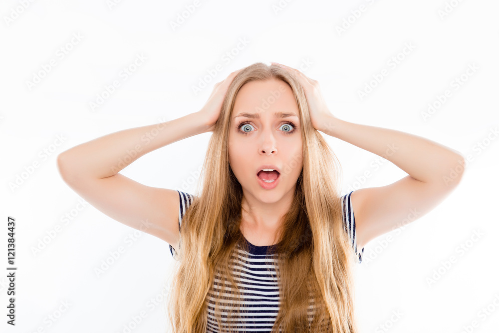 Portrait of young angry shocked woman holding head