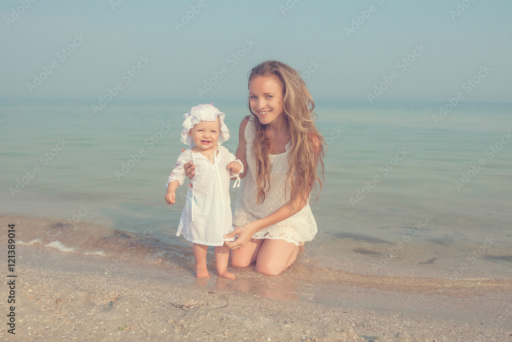 Happy beautiful mother and daughter enjoying beach time Happy beautiful mother and daughter enjoying beach time