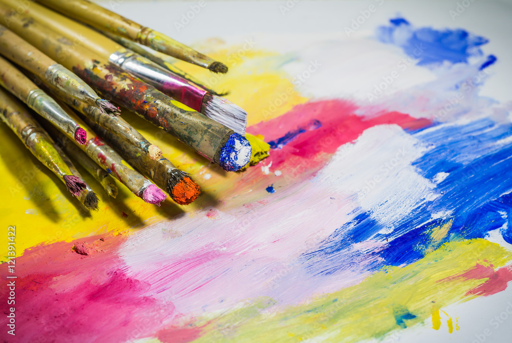 Fototapeta premium Paintbrushes with color on paper