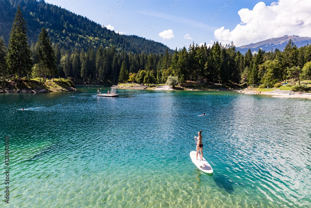 Girl on a paddleboard on the Caumasee in Switzerland