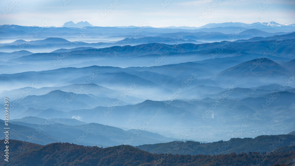 Fototapeta premium Rolling hills and mountains at autumn sunny day with fog, view from Zeljin mountain, Serbia