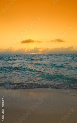 caribbean sunrise with wave on beach