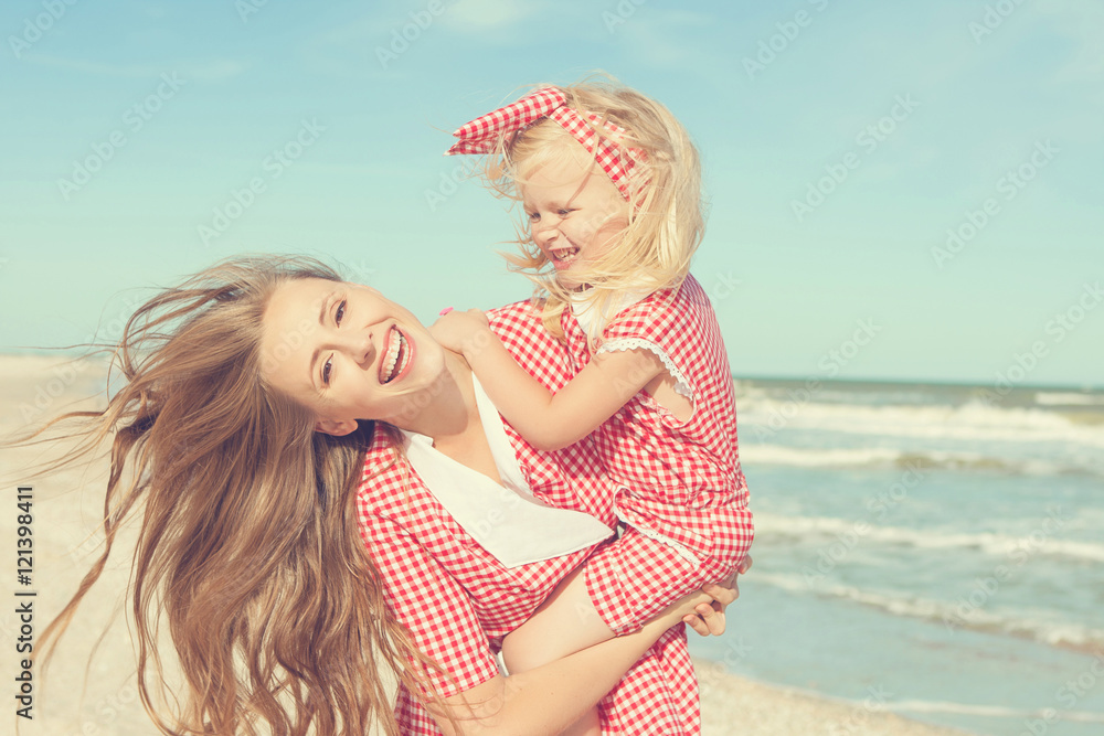 Mother and her daughter having fun on the beach Mother and her daughter having fun on the beach