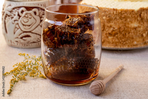 Honeycomb in glass jar. Autumn still life. Close up.