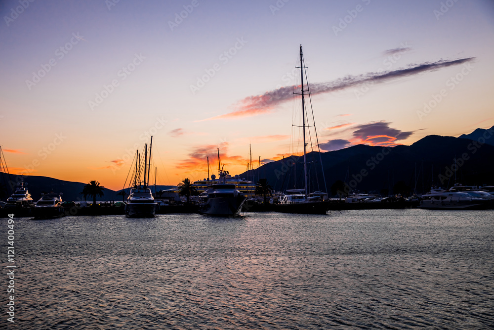 Sailing boats and yachts in marina. Porto Montenegro background on the sunset