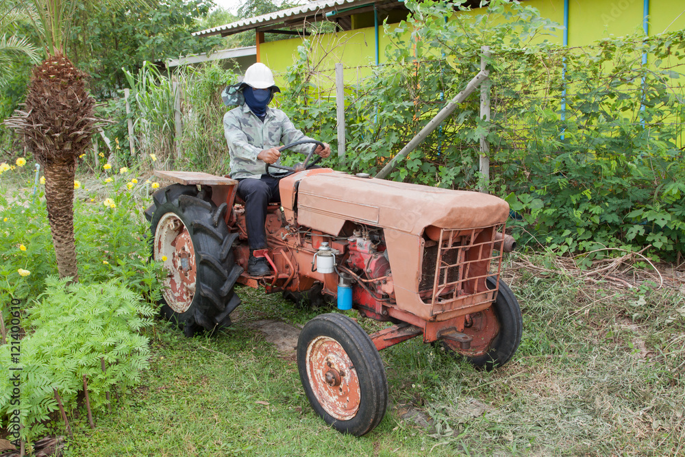 Workers orange tractor and mower Workers orange tractor and mower