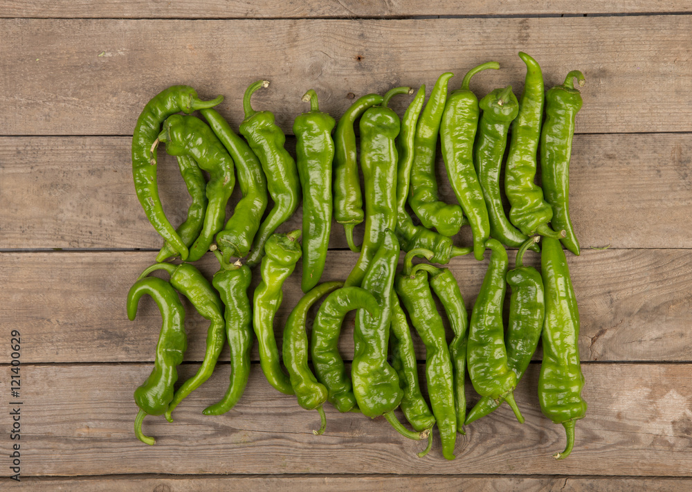 green pepperoni peppers on the wooden table green pepperoni peppers on the wooden table