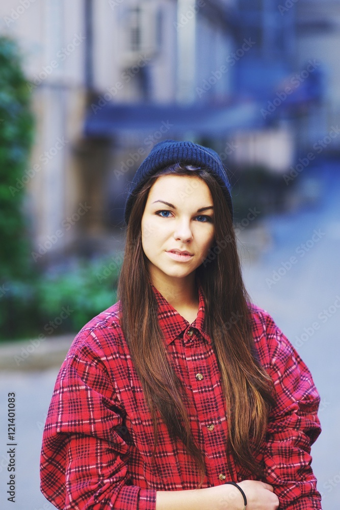 Close-up portrait of a beautiful young woman in  red plaid shirt