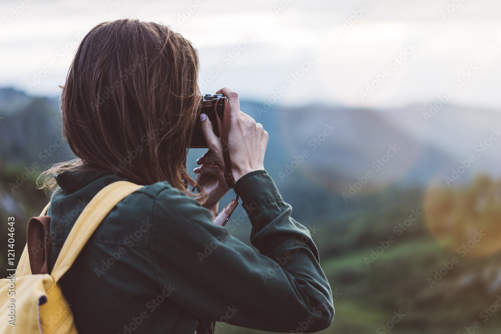 Tourist traveler photographer taking pictures of  landscape on vintage photo camera on background valley view mockup sun flare, hipster girl with backpack enjoying sunset on peak of foggy mountain