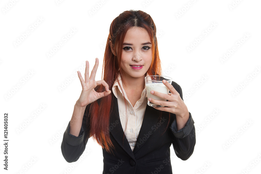 Healthy Asian woman drinking a glass of milk show OK sign. Healthy Asian woman drinking a glass of milk show OK sign.