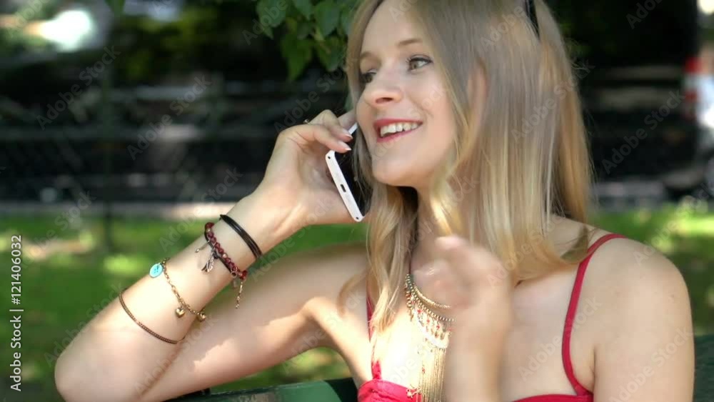 Beautiful girl sitting in the park and chatting on cellphone, steadycam shot
Beautiful girl sitting in the park and chatting on cellphone, steadycam shot