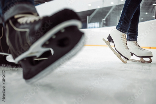 Man's hockey and women' figure skates on ice empty skating rink