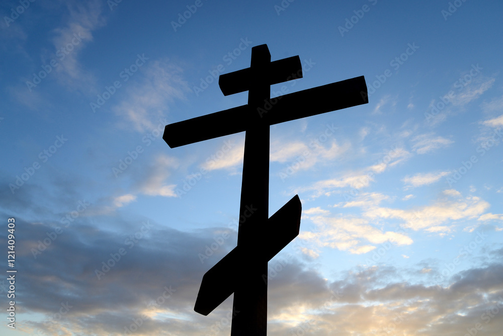 Orthodox cross on blue sky.