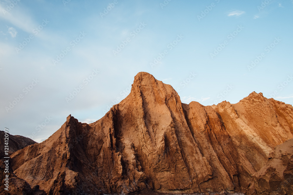 Golden rock formation with blue sky, Moon Valley, San Pedro De Atacama, Chile