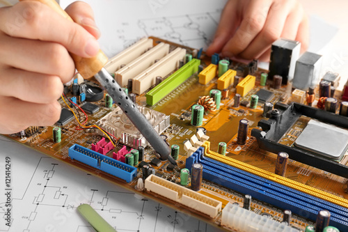 Man repairing motherboard, ...