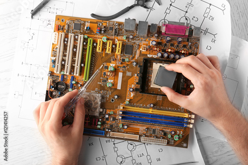 Man repairing motherboard, ...
