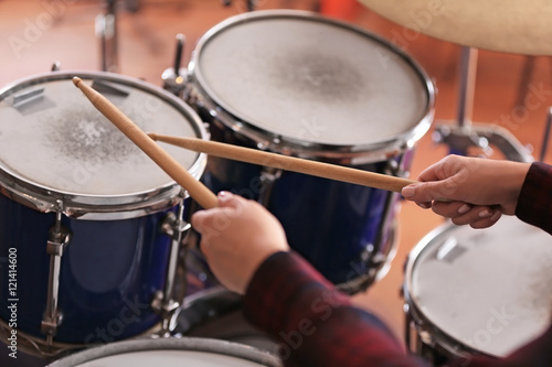 Woman playing drums in a recording studio