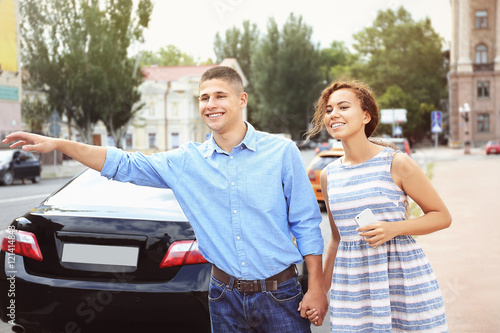 Young couple stopping taxi ...
