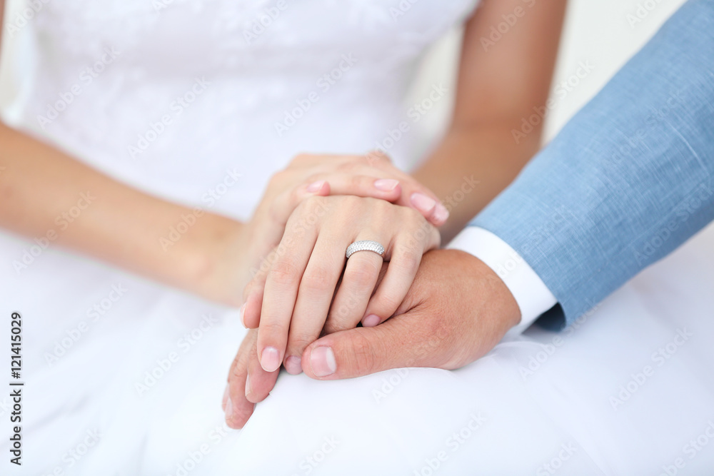 Bride and groom holding hands together indoor Bride and groom holding hands together indoor