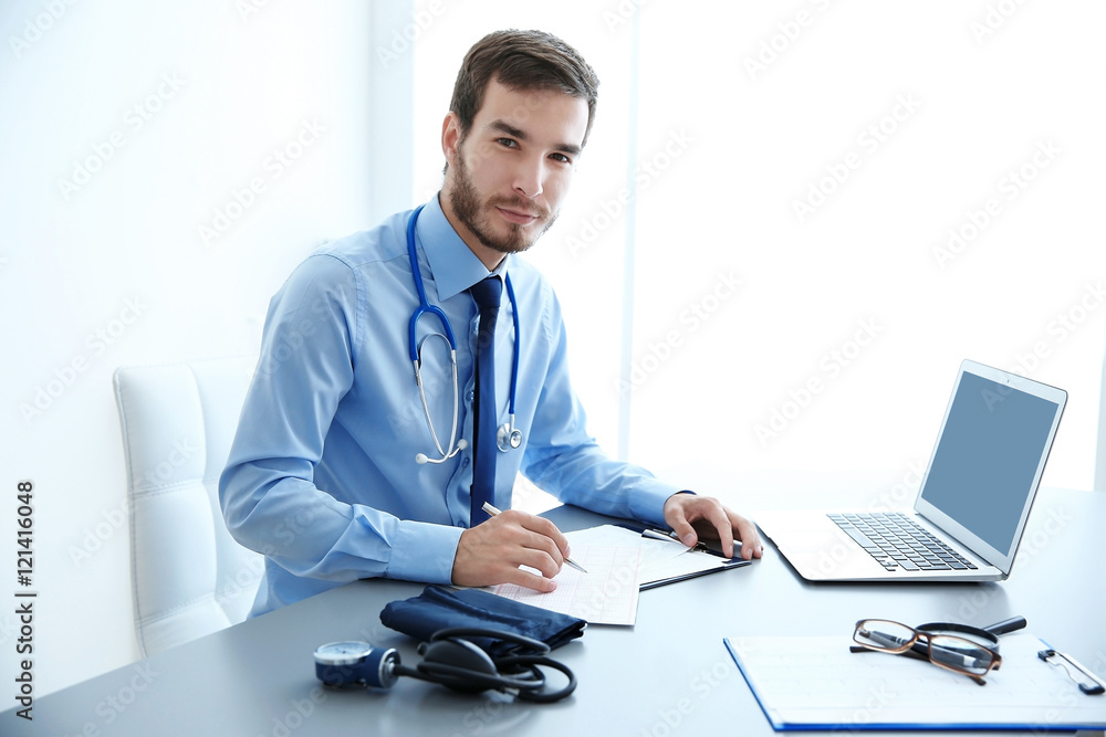 Fototapeta premium Male doctor at work in clinic office
