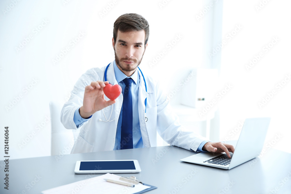 Male doctor at work in clinic office