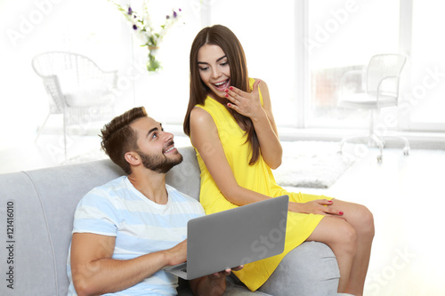 Beautiful young couple usin...