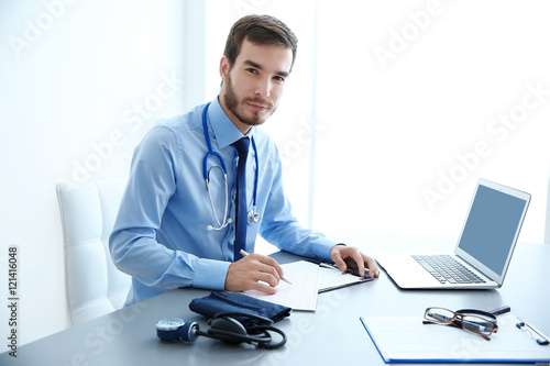 Male doctor at work in clinic office