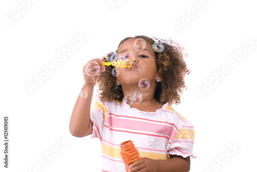 Valokuva Little girl blowing bubbles