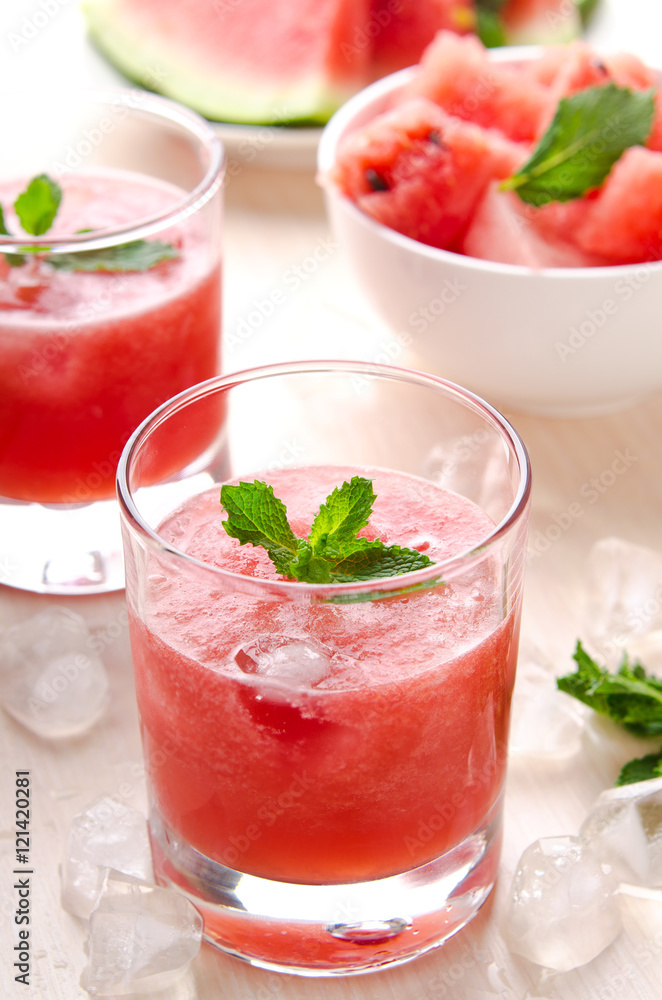 Healthy watermelon smoothie with mint and ice in glass Healthy watermelon smoothie with mint and ice in glass