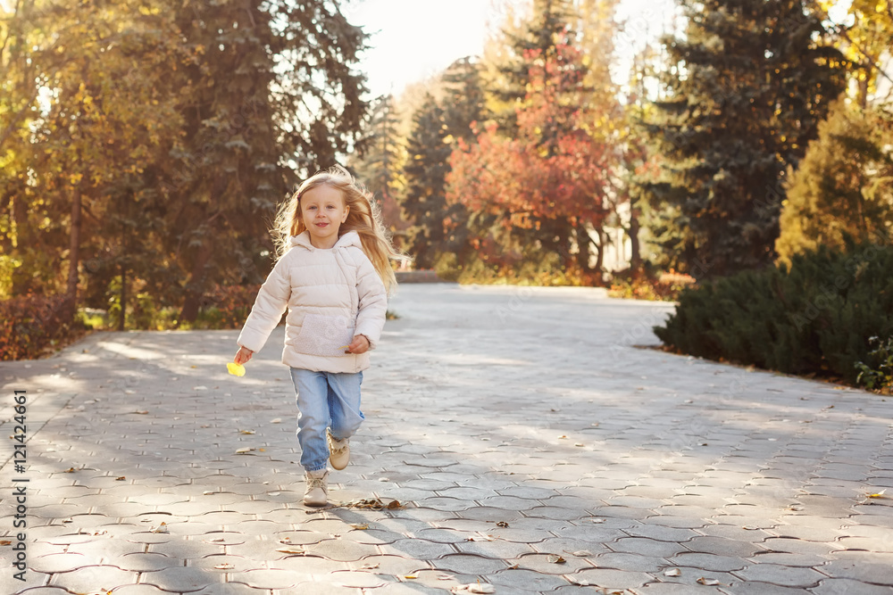 Little girl running in autumn park. Little girl running in autumn park.