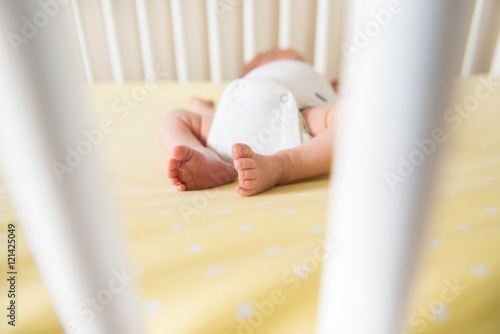 Tiny toes of baby in crib
