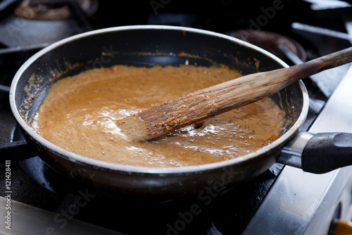 Curry soup is cooked in a pan.